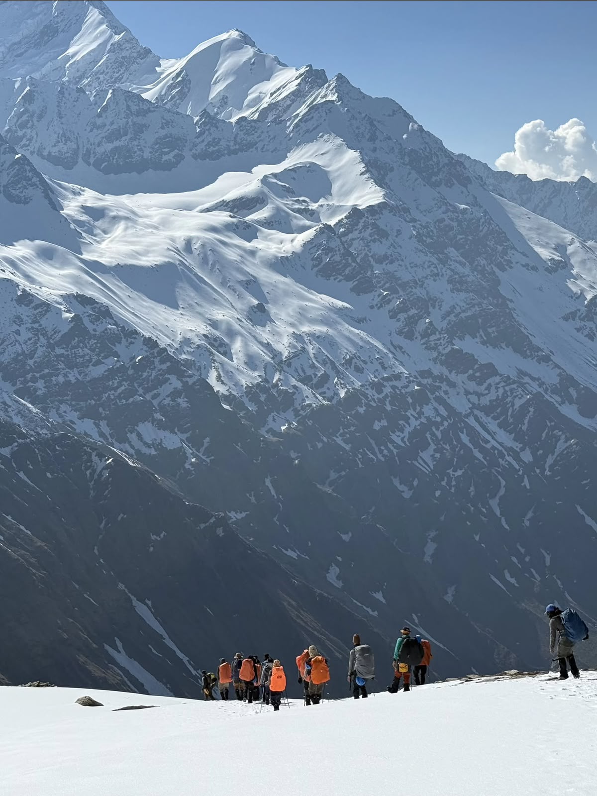 The team walking out under the hanging glaciers of Swargarohini