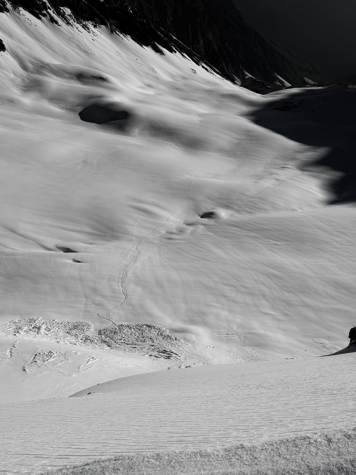 A single line of footprints across the upper snowfield
