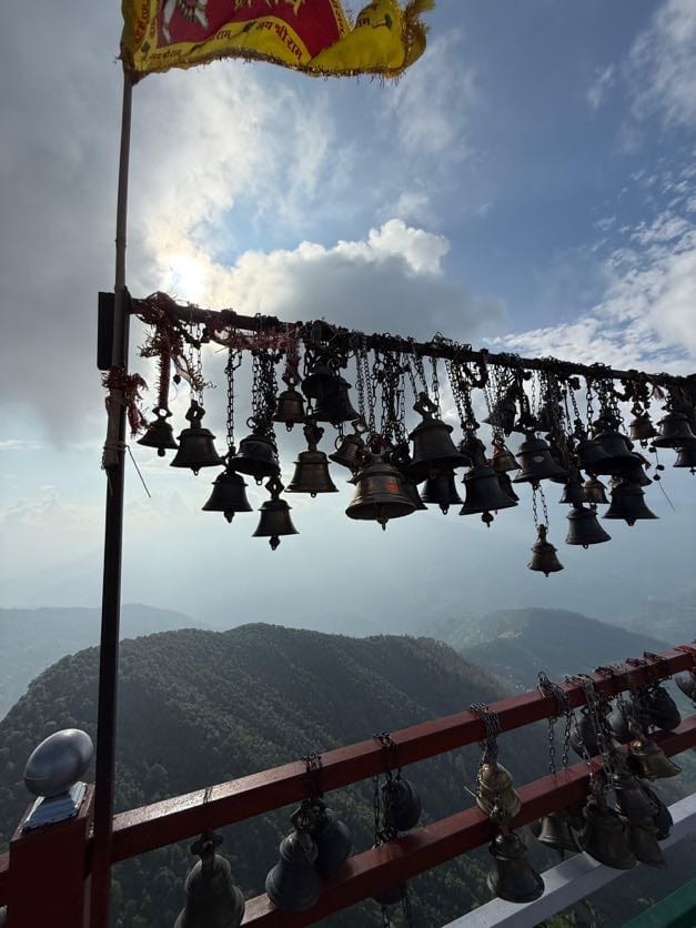 Brass bells hung along the railing above the valley